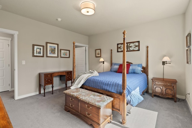 bedroom with light carpet and baseboards