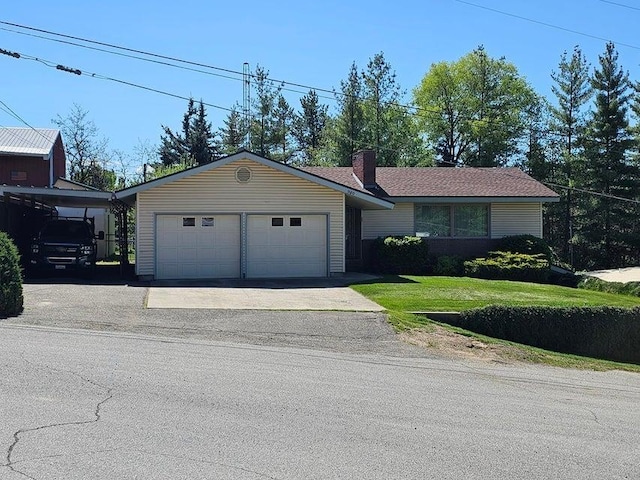 960 E Astor Ave, Colville, WA 99114 - ranch-style house with a front yard, concrete driveway, a chimney, and a garage