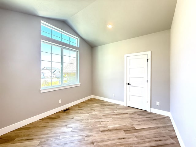 unfurnished room featuring vaulted ceiling, baseboards, a healthy amount of sunlight, and visible vents