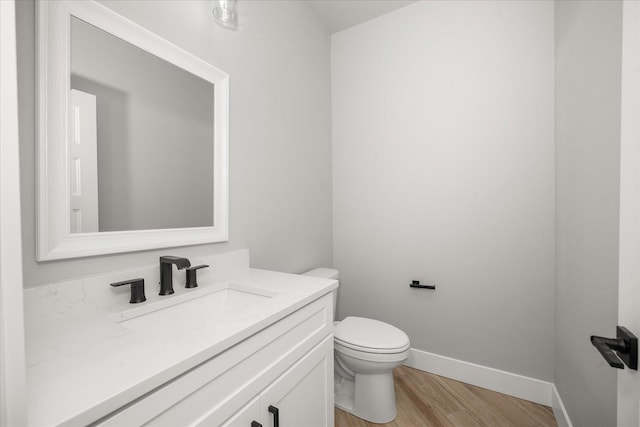 1715 S Lloyd Ln, Spokane, WA 99212 - bathroom with wood finished floors, vanity, toilet, and baseboards