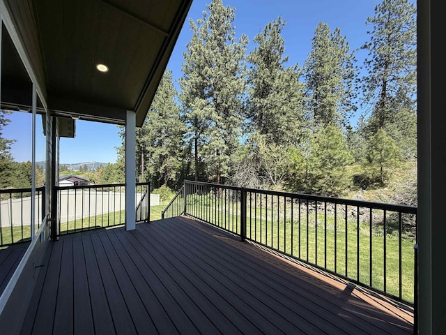 wooden deck with a lawn