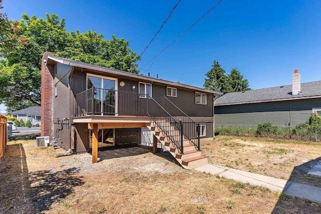 rear view of property with stairway