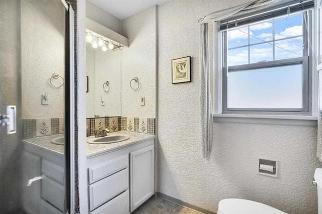 2424 W Fairview Ave, Spokane, WA 99205 - bathroom with toilet, a textured wall, and vanity