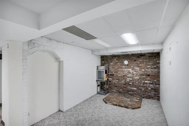 2424 W Fairview Ave, Spokane, WA 99205 - finished basement with carpet floors and brick wall