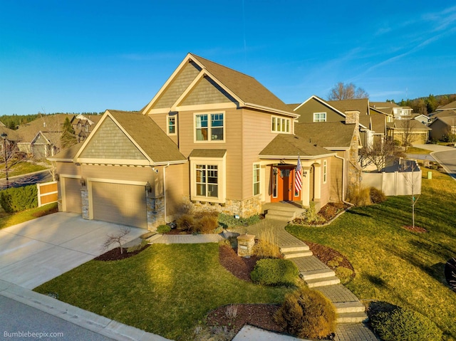 view of front of home featuring stone siding, an attached garage, a front yard, and driveway