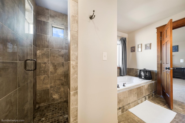full bath featuring a stall shower, a bath, and tile patterned floors