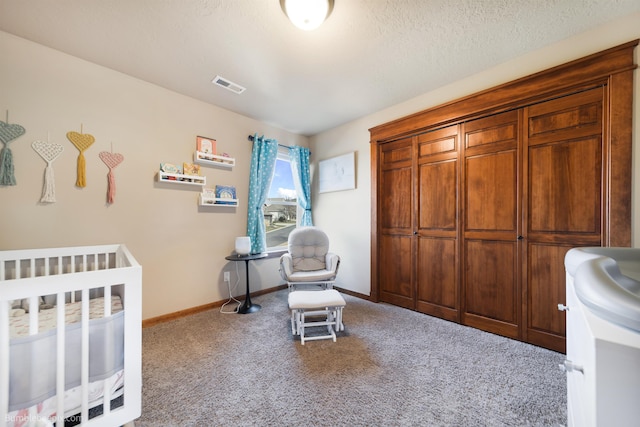 carpeted bedroom featuring baseboards and a nursery area