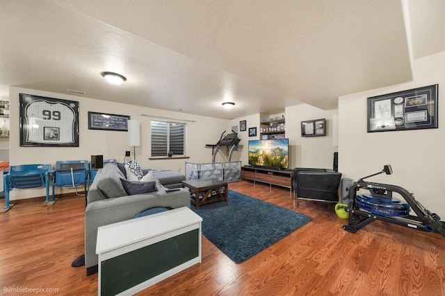 living room featuring wood finished floors and a textured ceiling
