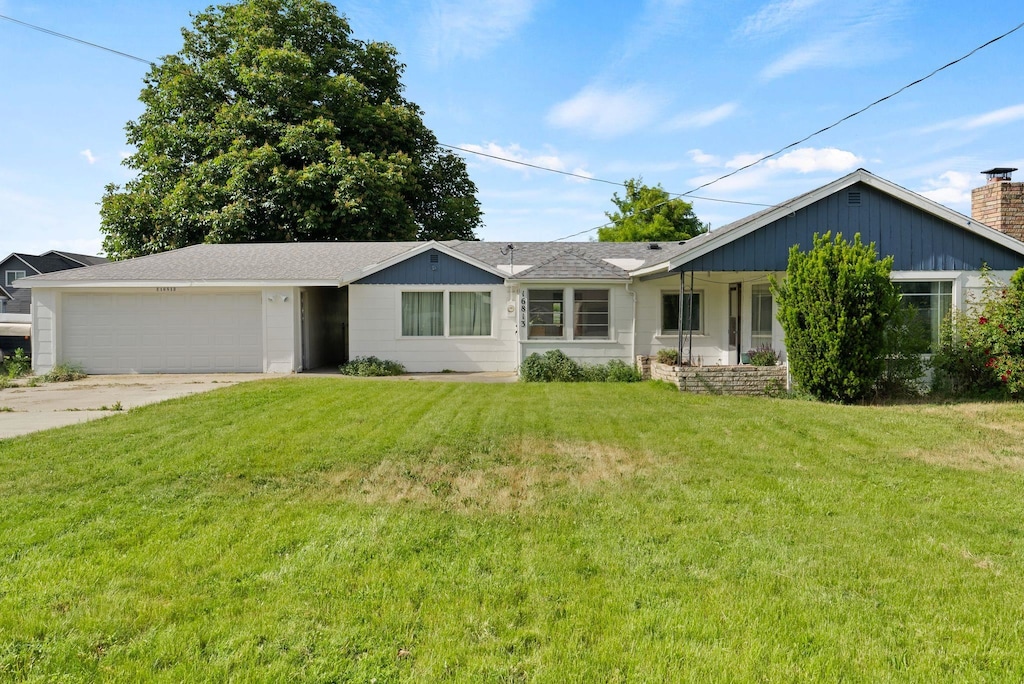 16813 E Valleyway Ave, Spokane Valley, WA 99037 - ranch-style house with a garage, concrete driveway, a front lawn, and a chimney