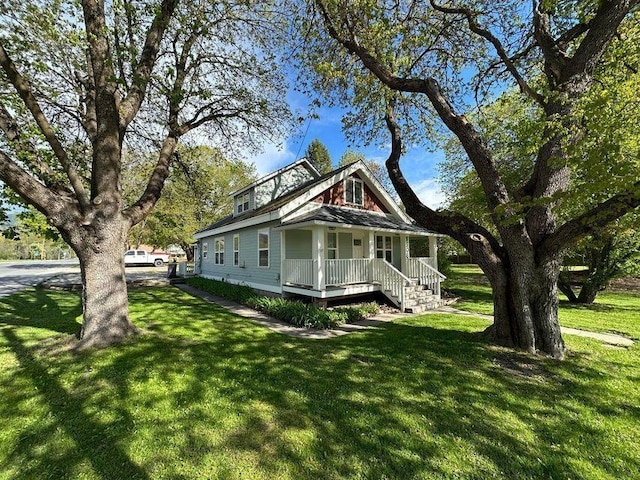 508 N 3rd St E, Chewelah, WA 99109 - view of front facade with covered porch and a front yard