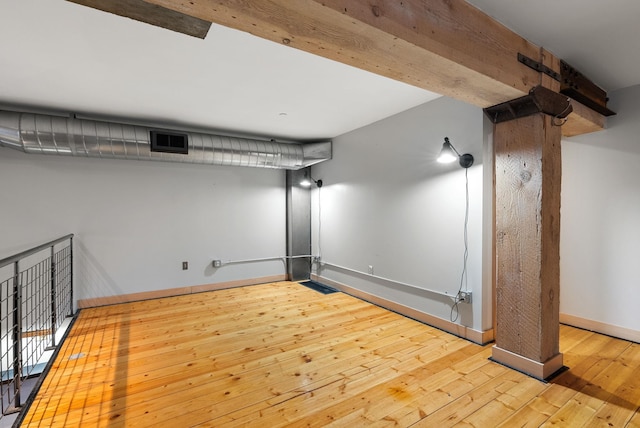 finished below grade area featuring wood-type flooring and baseboards
