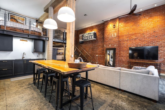 1016 W Railroad Ave Unit 202, Spokane, WA 99201 - dining area featuring a towering ceiling and concrete flooring