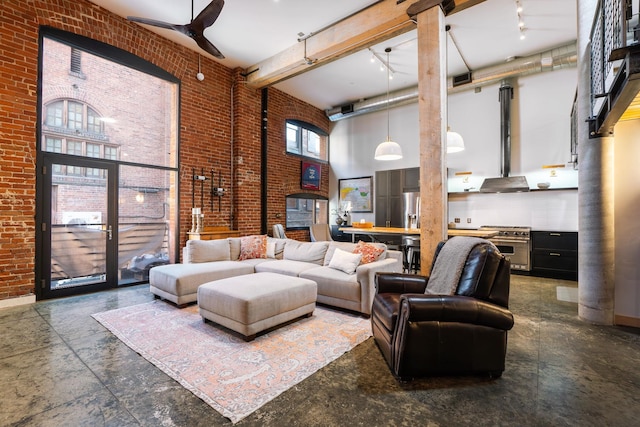 1016 W Railroad Ave Unit 202, Spokane, WA 99201 - living room with a high ceiling, ceiling fan, brick wall, and concrete floors