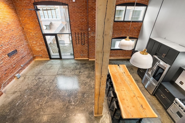 foyer featuring healthy amount of natural light and brick wall