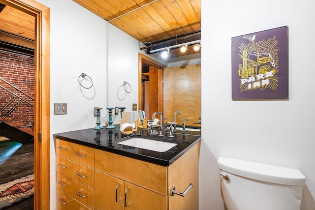 1016 W Railroad Ave Unit 202, Spokane, WA 99201 - half bathroom with track lighting, toilet, vanity, and wood ceiling