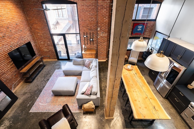 1016 W Railroad Ave Unit 202, Spokane, WA 99201 - living room with healthy amount of natural light, a towering ceiling, and concrete floors