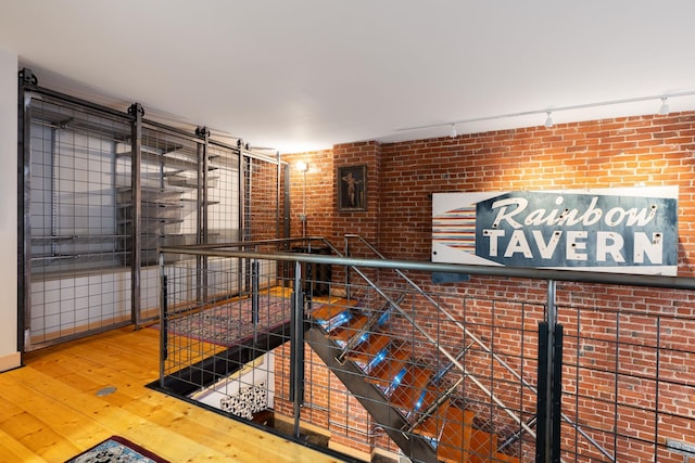 1016 W Railroad Ave Unit 202, Spokane, WA 99201 - corridor with hardwood / wood-style flooring and brick wall