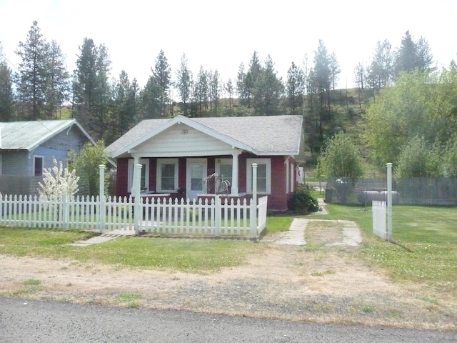view of front of house with covered porch and a fenced front yard