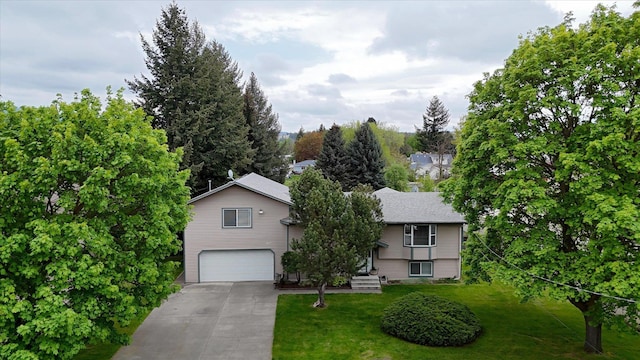 view of front of house with a garage, driveway, and a front lawn