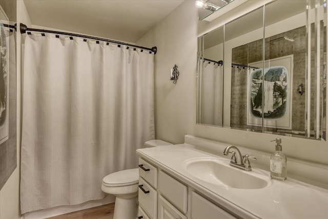bathroom with toilet, vanity, wood finished floors, and shower / tub combo