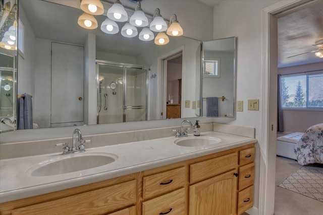 ensuite bathroom featuring a stall shower and double vanity
