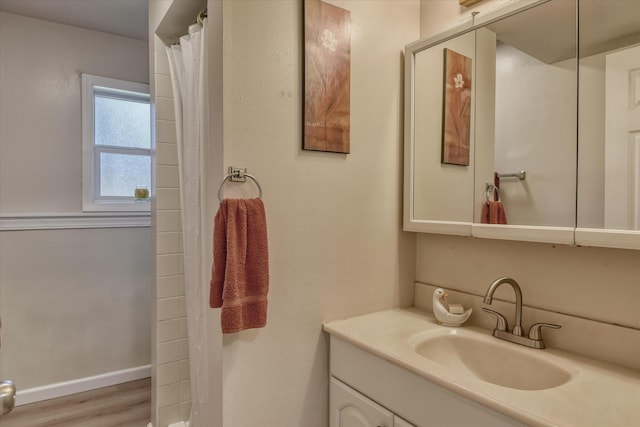 bathroom with vanity, wood finished floors, baseboards, and a shower with shower curtain