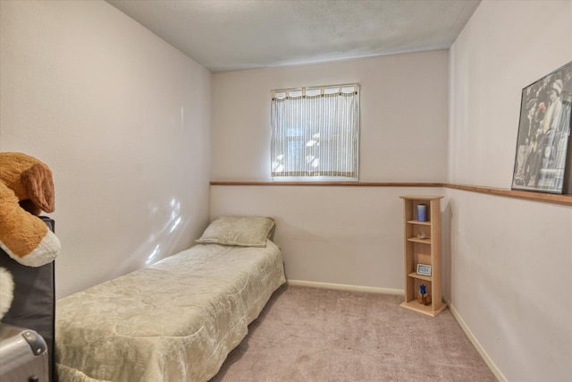 bedroom featuring carpet floors and baseboards