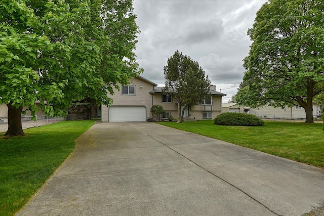 tri-level home with an attached garage and concrete driveway