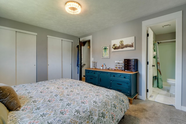 5212 N Bellevue Ct, Spokane Valley, WA 99216 - bedroom with light carpet, multiple closets, and ensuite bath