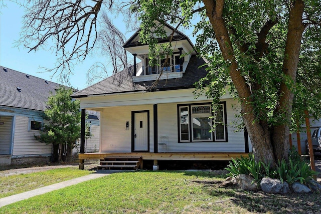 1121 W Knox Ave, Spokane, WA 99205 - view of front of house with a porch, a front lawn, and a shingled roof