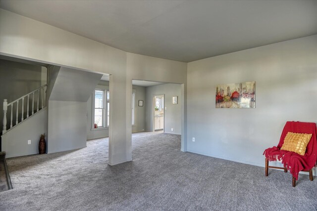 1121 W Knox Ave, Spokane, WA 99205 - unfurnished living room featuring carpet floors, stairs, and baseboards