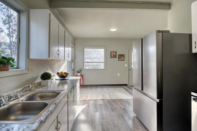 1121 W Knox Ave, Spokane, WA 99205 - kitchen with freestanding refrigerator, a sink, light wood-type flooring, white cabinetry, and light countertops
