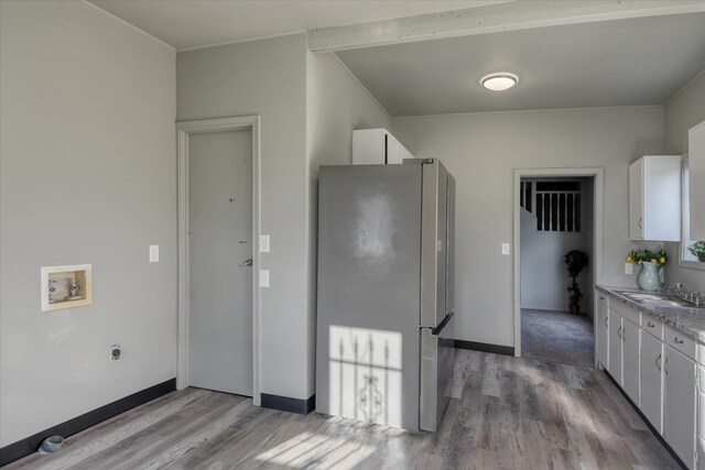 1121 W Knox Ave, Spokane, WA 99205 - kitchen featuring freestanding refrigerator, light wood-style floors, white cabinetry, a sink, and light countertops