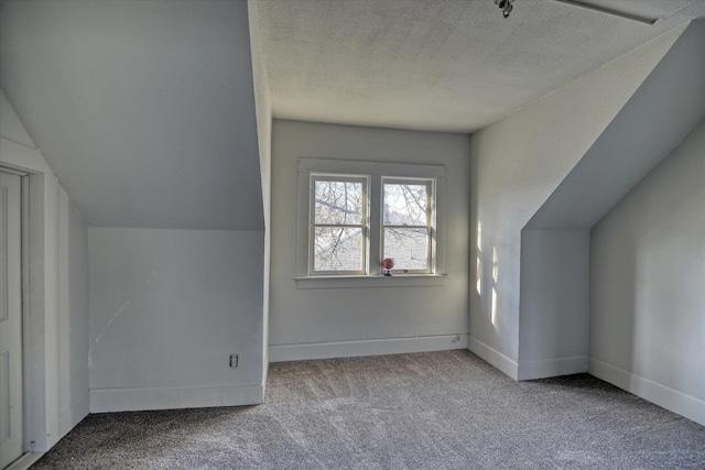 1121 W Knox Ave, Spokane, WA 99205 - additional living space featuring carpet flooring, a textured ceiling, baseboards, and lofted ceiling