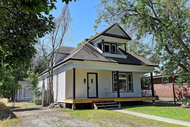 1121 W Knox Ave, Spokane, WA 99205 - view of front of property featuring a porch, a shingled roof, and a chimney