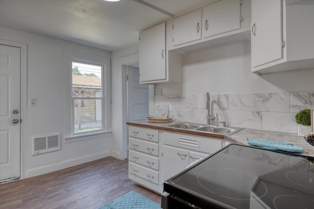324 E Everett Ave, Spokane, WA 99207 - kitchen featuring a sink, wood finished floors, white cabinetry, decorative backsplash, and black / electric stove