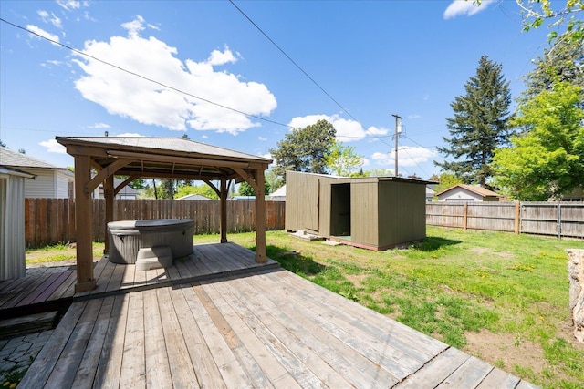 1207 E Wabash Ave, Spokane, WA 99207 - wooden deck with a hot tub, a gazebo, a storage unit, and an outbuilding