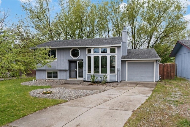 15121 N Meadowview Dr, Mead, WA 99021 - bi-level home featuring an attached garage, concrete driveway, a chimney, and a shingled roof