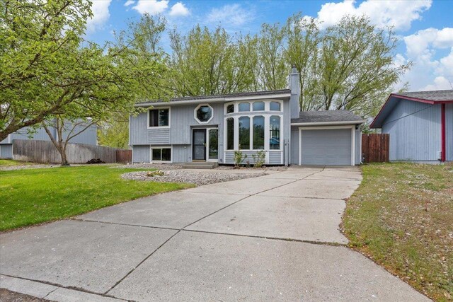 15121 N Meadowview Dr, Mead, WA 99021 - bi-level home with a garage, concrete driveway, and a chimney