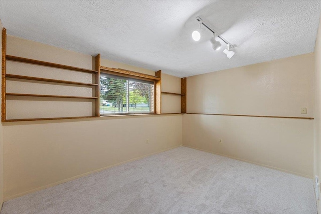 15121 N Meadowview Dr, Mead, WA 99021 - carpeted spare room with a textured ceiling, rail lighting, and baseboards