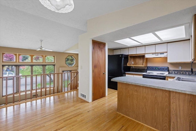 15121 N Meadowview Dr, Mead, WA 99021 - kitchen featuring electric range oven, freestanding refrigerator, a peninsula, white cabinetry, and light wood-style floors