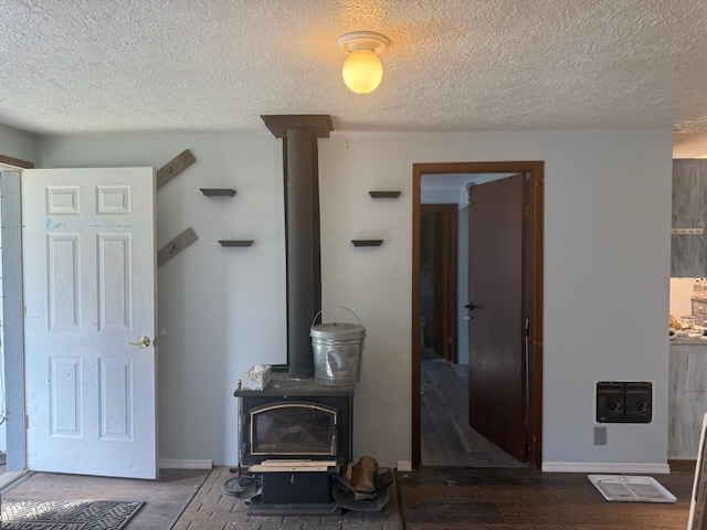 1468 Veit Rd, Newport, WA 99156 - living area featuring a wood stove, a textured ceiling, and baseboards