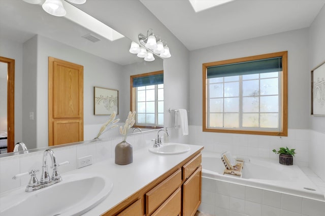 bathroom with a bath and double vanity