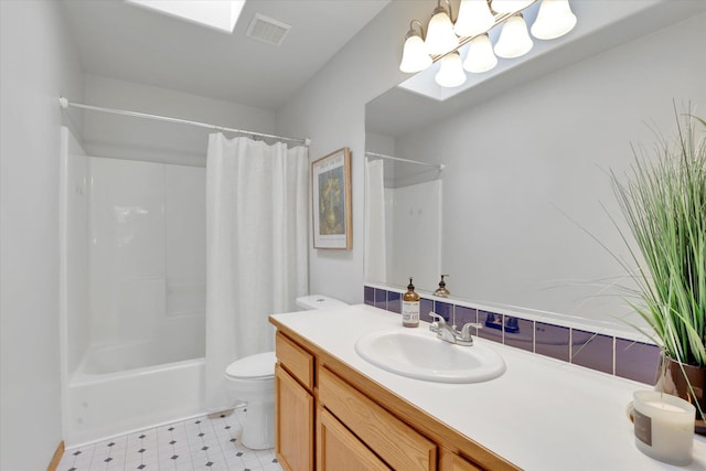bathroom with toilet, tile patterned floors, vanity, a skylight, and shower / bath combination with curtain
