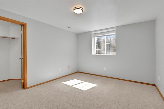 unfurnished bedroom featuring carpet floors, baseboards, and a closet