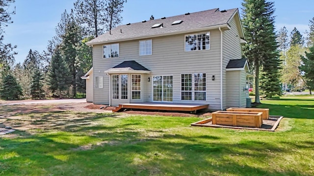 back of property with a lawn and a wooden deck