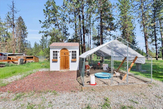 view of poultry coop featuring fence