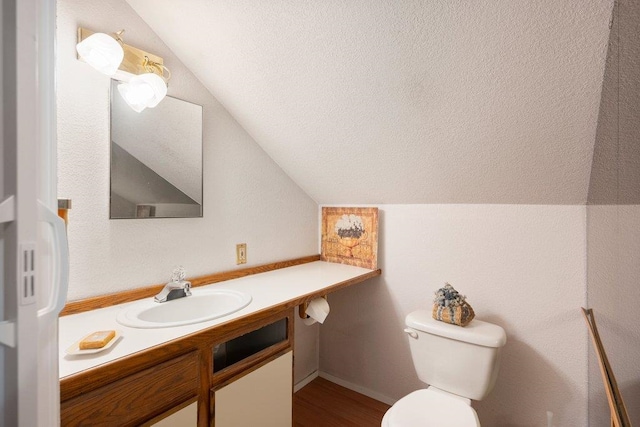 1725 N Park Rd, Spokane Valley, WA 99212 - bathroom featuring vaulted ceiling, vanity, toilet, and wood finished floors