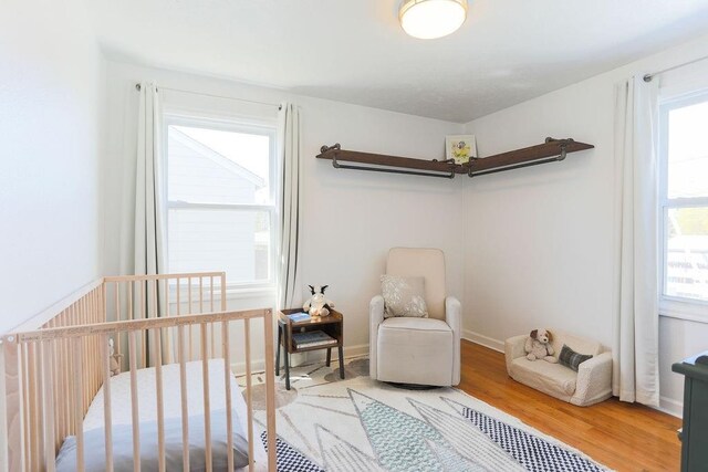 2804 W Crown Ave, Spokane, WA 99205 - bedroom featuring light wood-style floors, a nursery area, and baseboards
