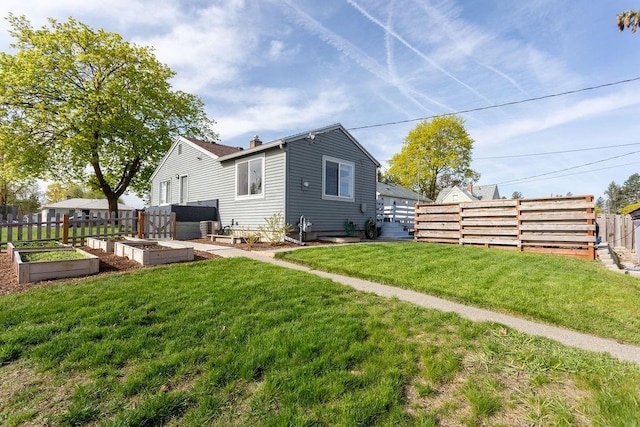 2804 W Crown Ave, Spokane, WA 99205 - rear view of house with a vegetable garden and a chimney